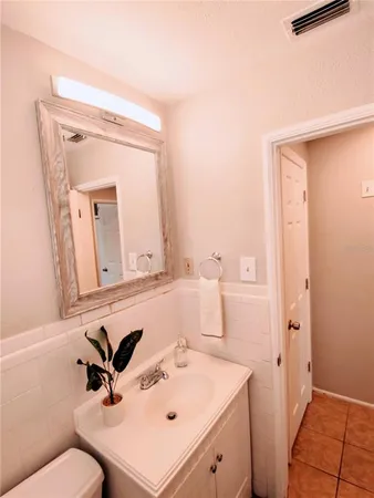 a bathroom with a sink mirror vanity and toilet