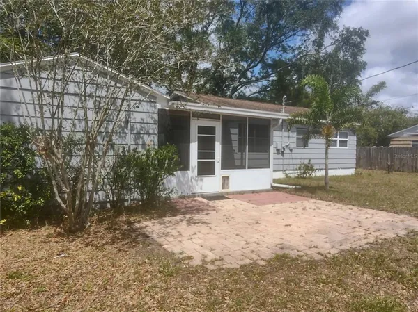 a front view of house with yard and trees