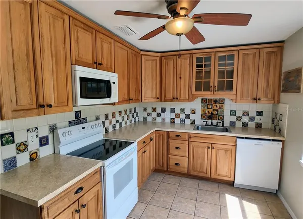 a kitchen with a sink cabinets and window
