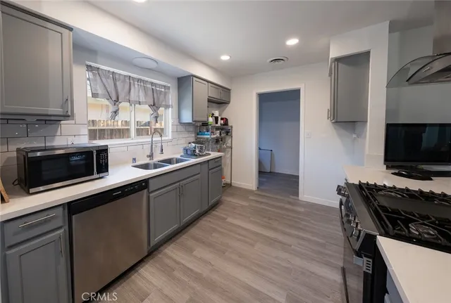 a kitchen with a sink stove and microwave
