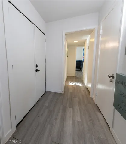 a view of an empty room with painting on the wall and a window