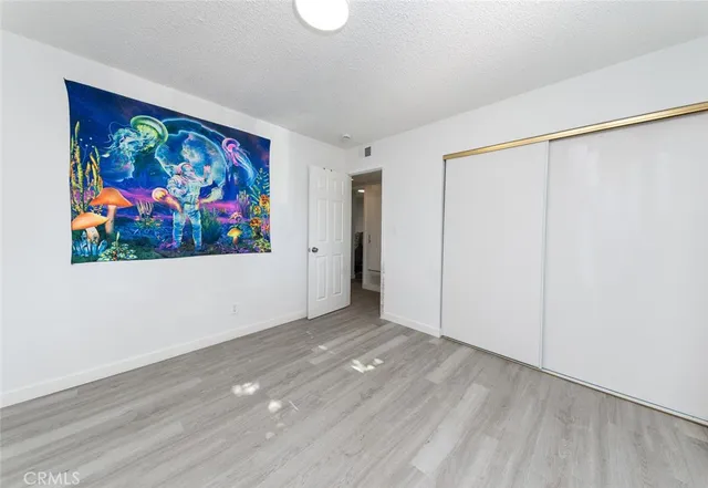 a bed sitting in a bedroom next to a window