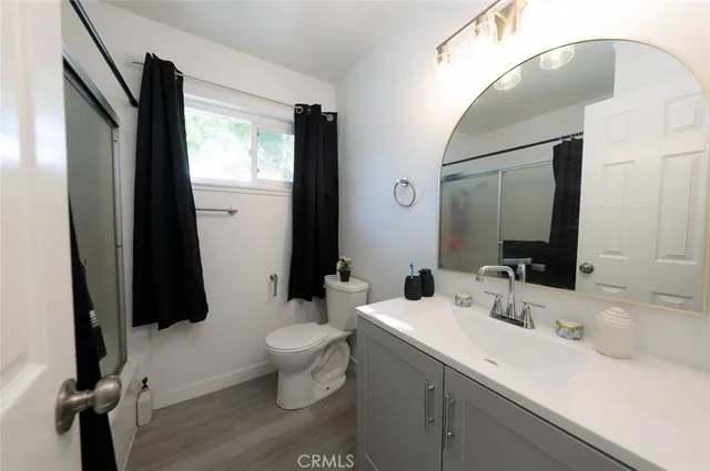 a bathroom with a sink toilet and a mirror