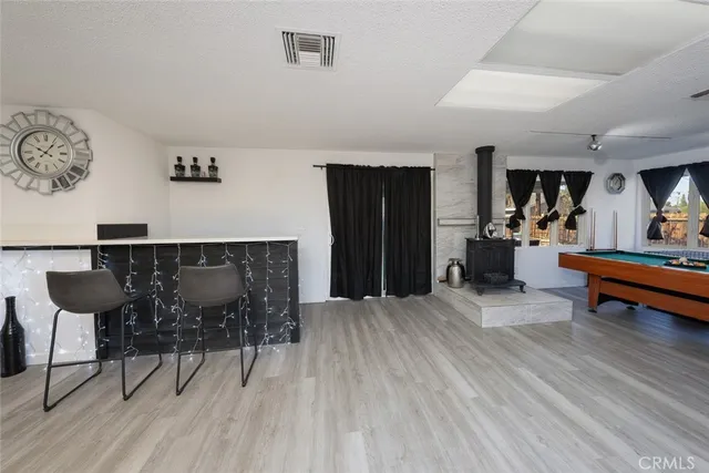 a living room with furniture a table and kitchen appliances