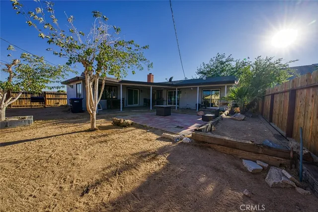 a view of patio with table and chairs potted plants