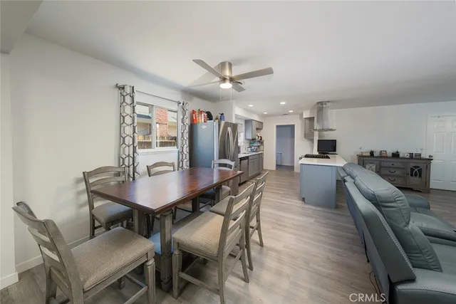 a view of a dining room with furniture and a kitchen