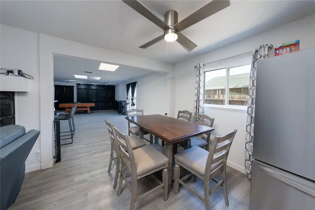 a dining room with furniture and a floor to ceiling window