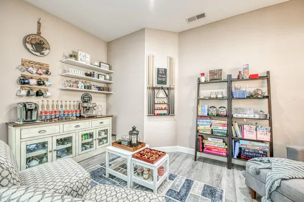 a living room with furniture and a book shelf