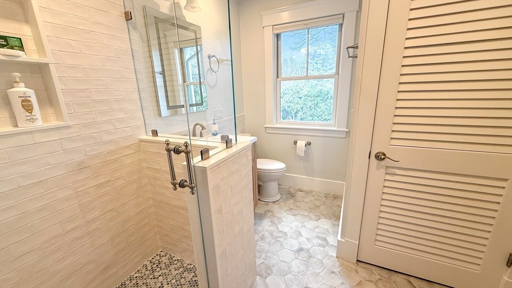 5 Walnut Street Lexington, MA 02421 - Photo 15 of 34 a bathroom with a sink toilet and shower