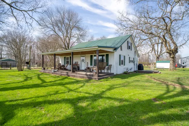 a front view of house with yard and trees