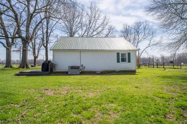 a view of a backyard with large trees