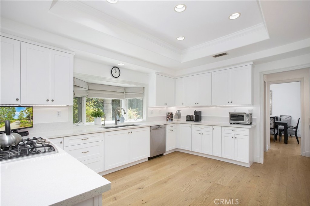 11376 Loch Lomond Road Los Alamitos, CA 90720 - Photo 12 of 32 a kitchen with granite countertop a sink and white cabinets