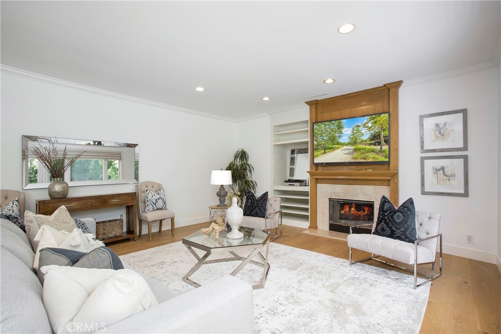 11376 Loch Lomond Road Los Alamitos, CA 90720 - Photo 14 of 32 a living room with furniture a fireplace and a flat screen tv
