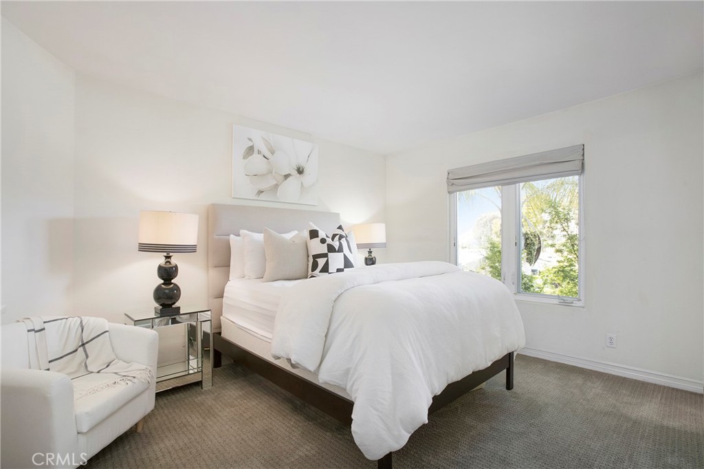 11376 Loch Lomond Road Los Alamitos, CA 90720 - Photo 22 of 32 a bedroom with a bed and a window