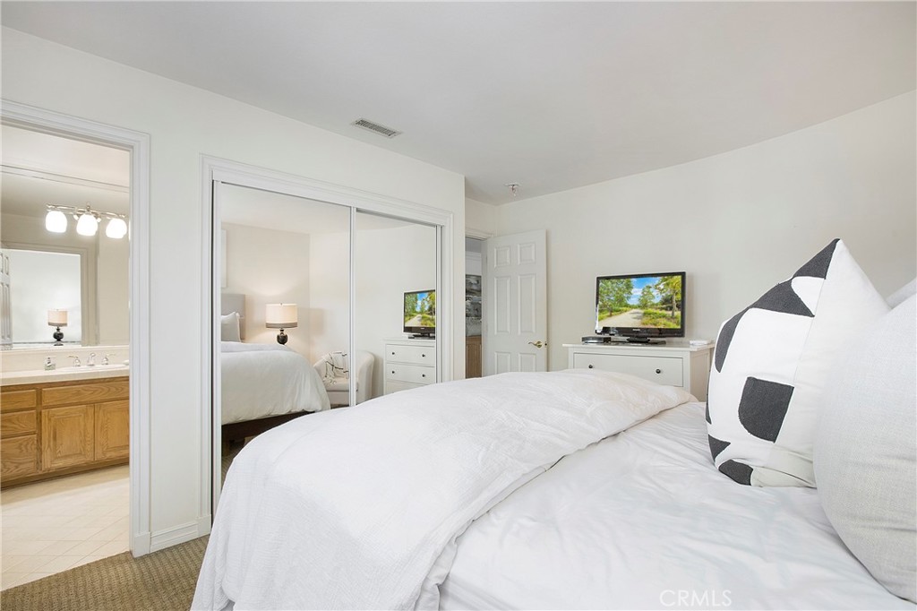11376 Loch Lomond Road Los Alamitos, CA 90720 - Photo 23 of 32 a spacious bedroom with a bed and a dresser