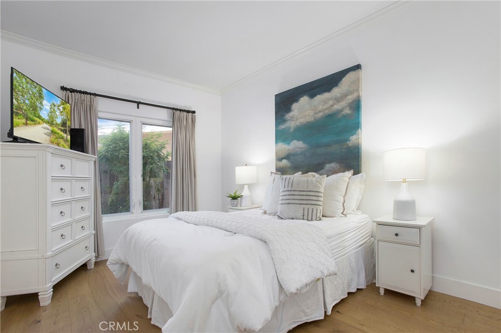 11376 Loch Lomond Road Los Alamitos, CA 90720 - Photo 26 of 32 a bedroom with a large bed and a large window