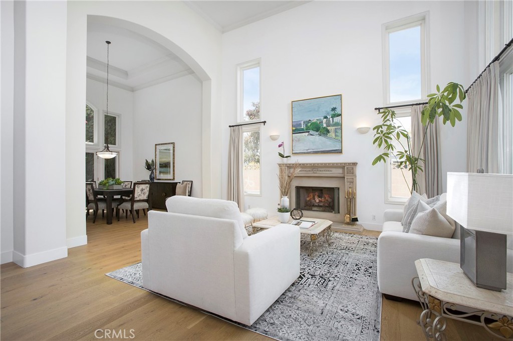 11376 Loch Lomond Road Los Alamitos, CA 90720 - Photo 4 of 32 a living room with furniture a fireplace and a potted plant
