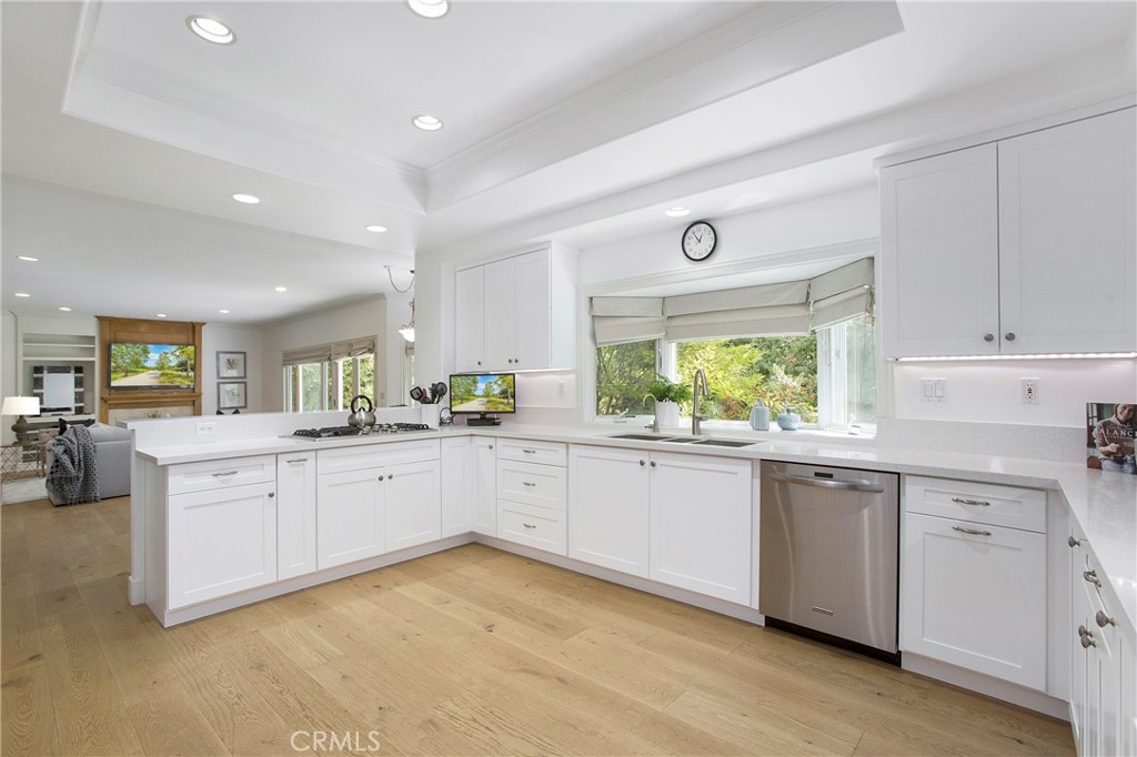 11376 Loch Lomond Road Los Alamitos, CA 90720 - Photo 10 of 32 a kitchen with granite countertop white cabinets and white appliances