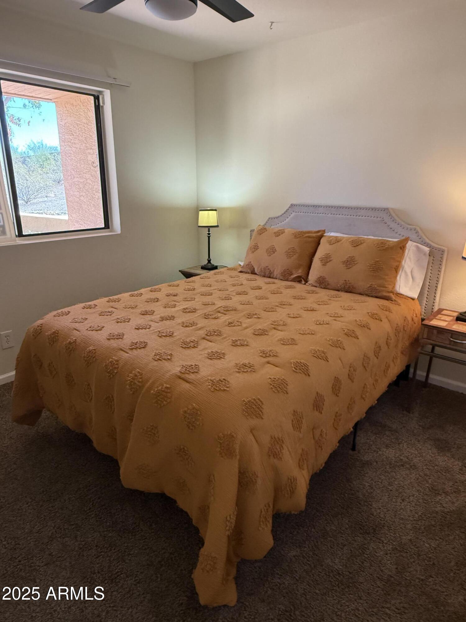 540 South West Road, Unit 24 Wickenburg, AZ 85390 - Photo 11 of 23 a bed sitting in a bedroom next to a window