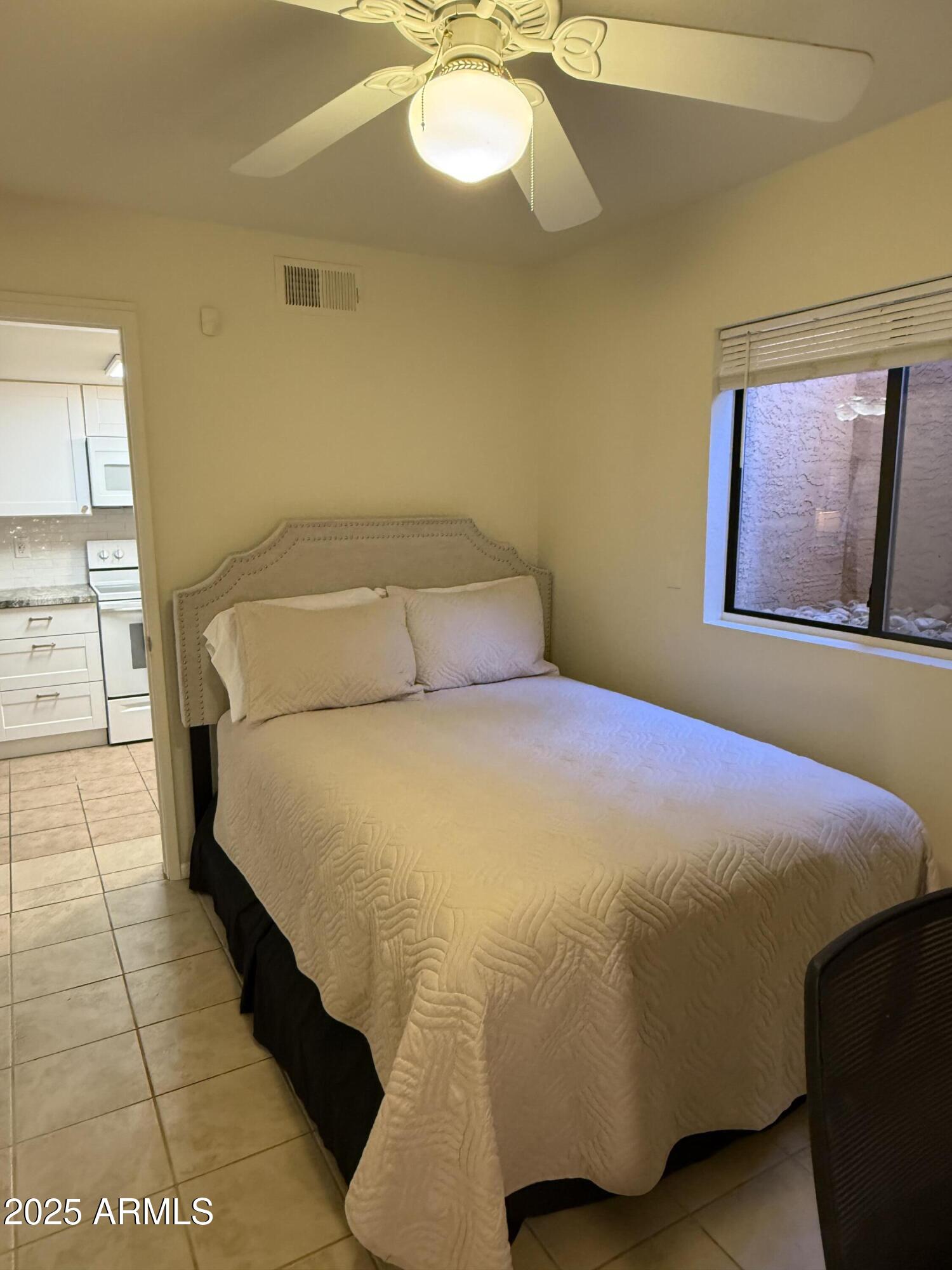 540 South West Road, Unit 24 Wickenburg, AZ 85390 - Photo 12 of 23 a bedroom with a bed and window