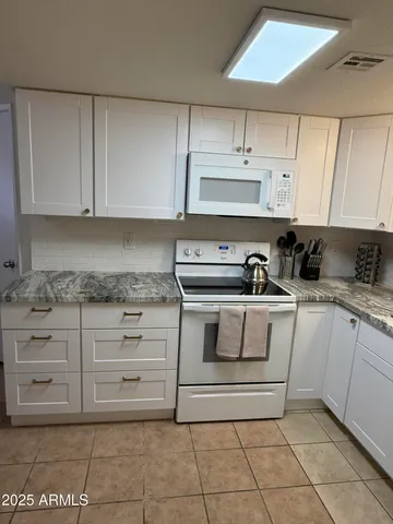 a kitchen with cabinets and appliances