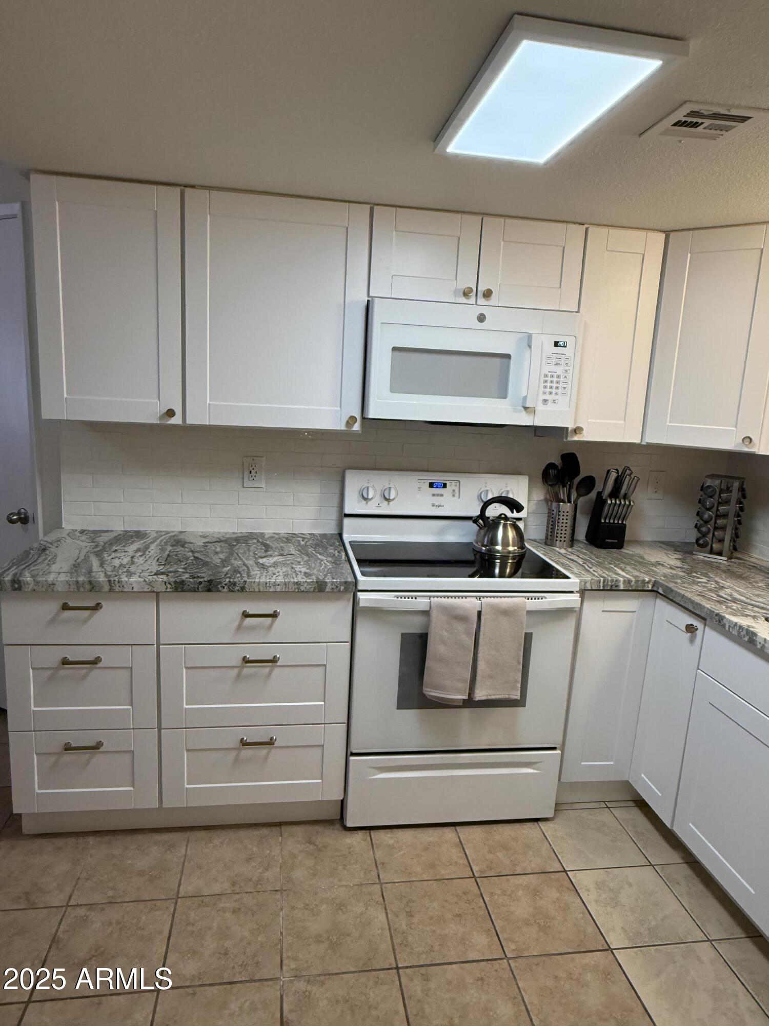 540 South West Road, Unit 24 Wickenburg, AZ 85390 - Photo 2 of 23 a kitchen with cabinets and appliances