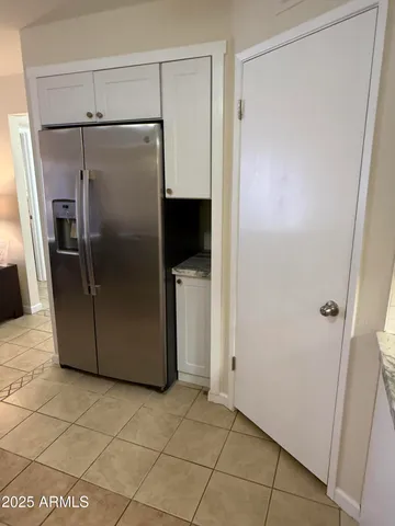 a metallic refrigerator freezer sitting in a kitchen