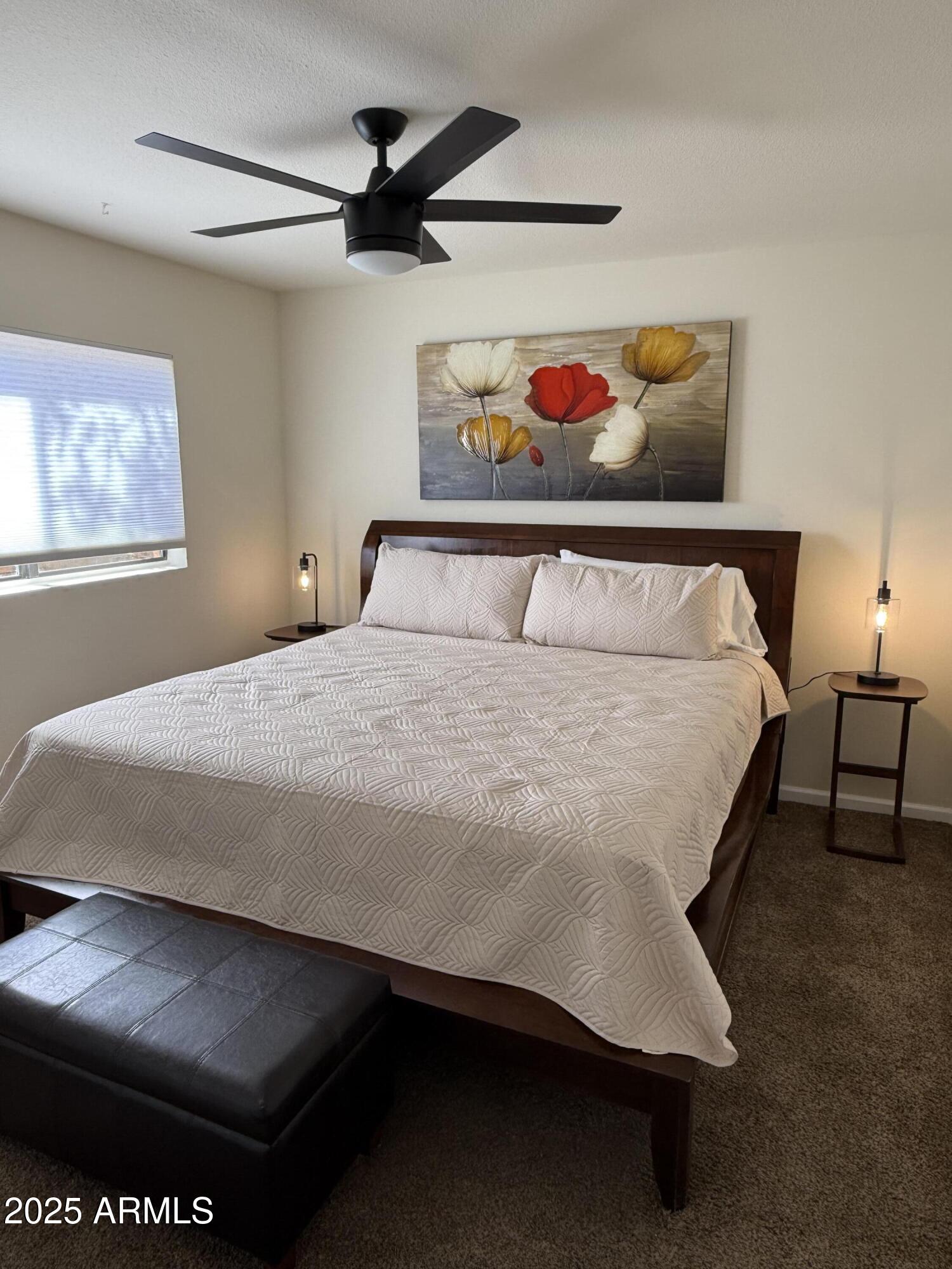 540 South West Road, Unit 24 Wickenburg, AZ 85390 - Photo 10 of 23 a bedroom with a bed and a chandelier