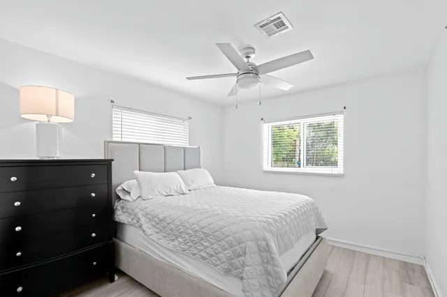 a bedroom with a large bed and a window