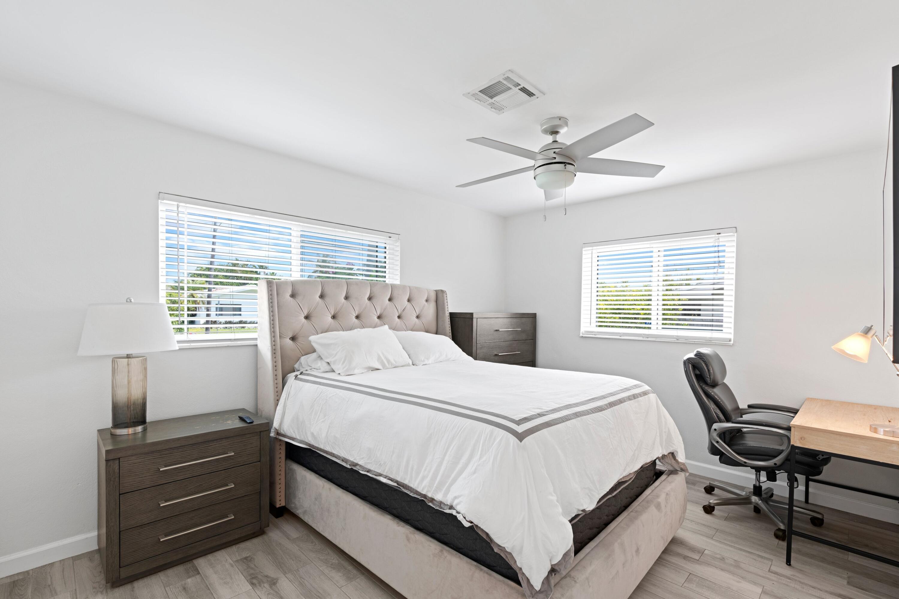 226 Southwest 13th Avenue Boynton Beach, FL 33435 - Photo 12 of 16 a bedroom with a bed and a ceiling fan