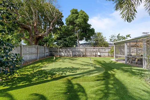 a view of a backyard with swimming pool