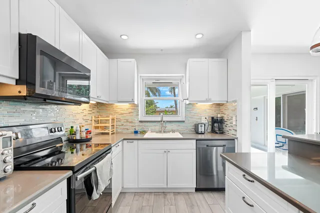 a kitchen that has a sink and a stove in it