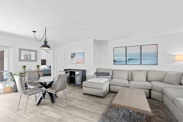 a living room with furniture a couch and a window