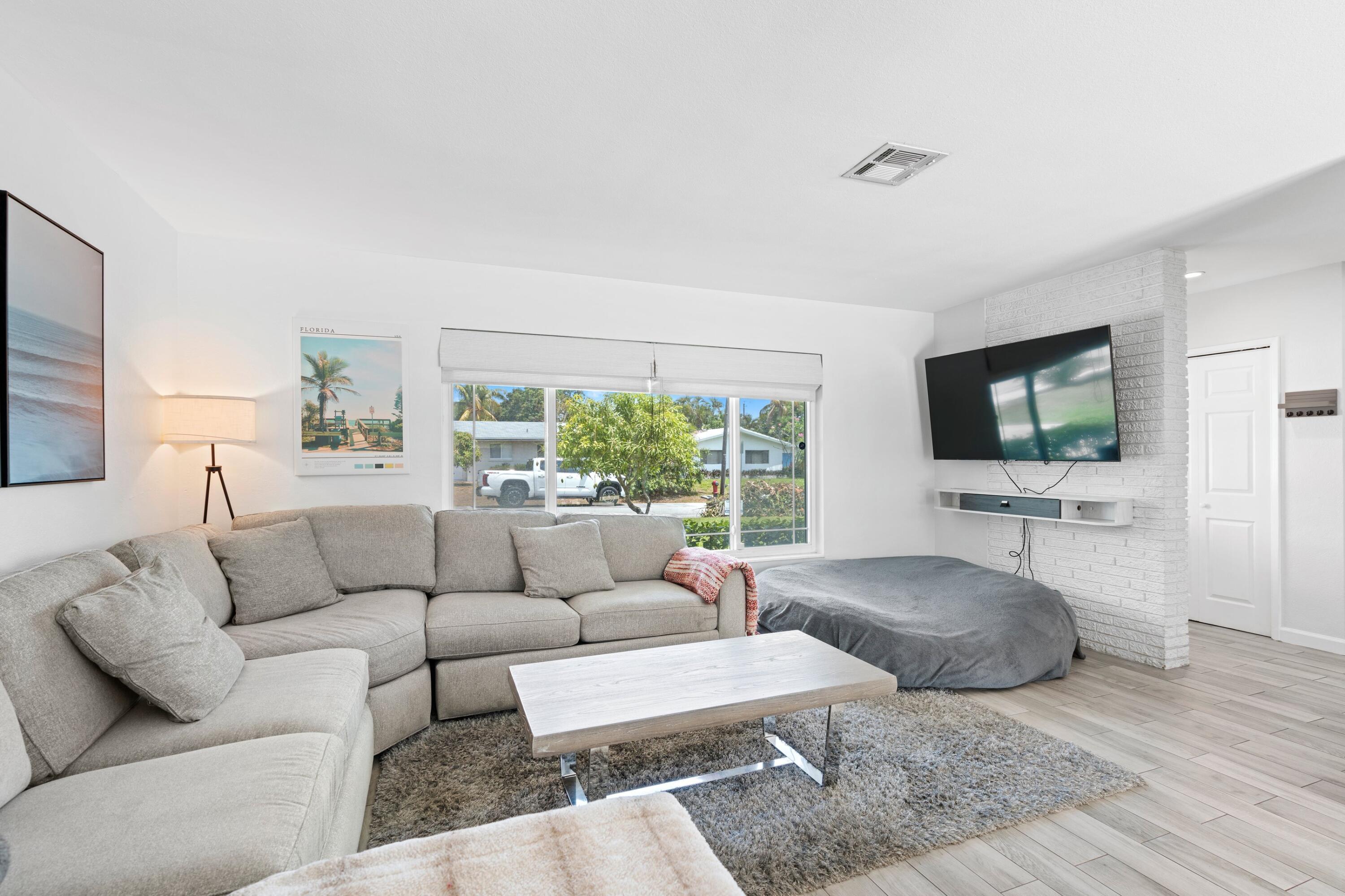226 Southwest 13th Avenue Boynton Beach, FL 33435 - Photo 6 of 16 a living room with furniture and a flat screen tv