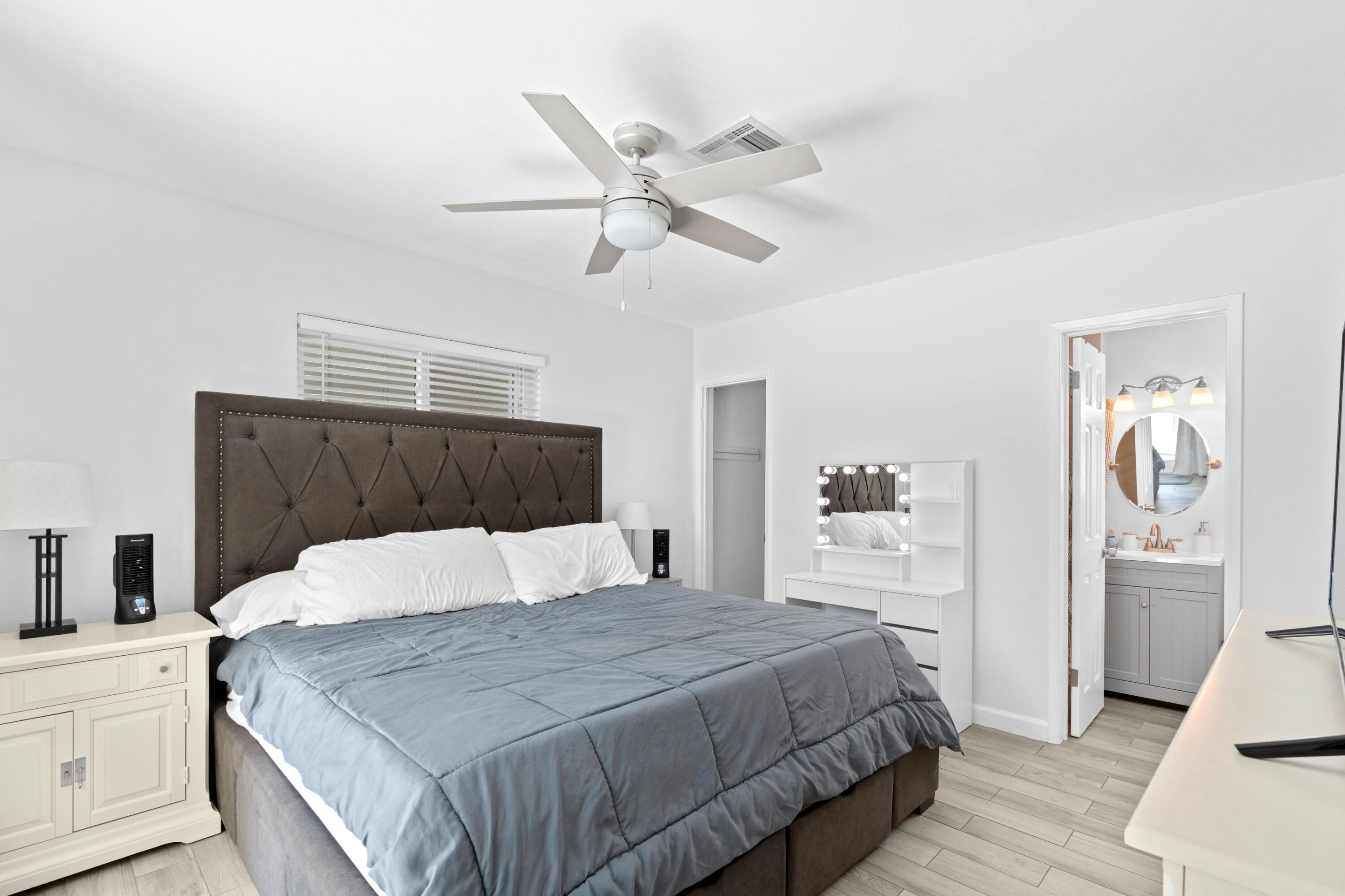 226 Southwest 13th Avenue Boynton Beach, FL 33435 - Photo 9 of 16 a bedroom with a large bed and a chandelier