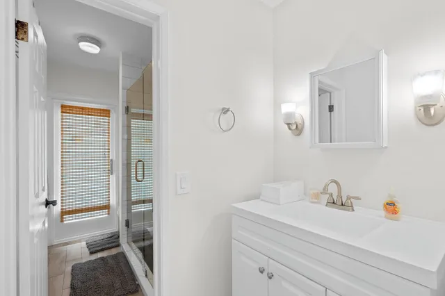 a en suite bathroom with a sink a mirror and a shower