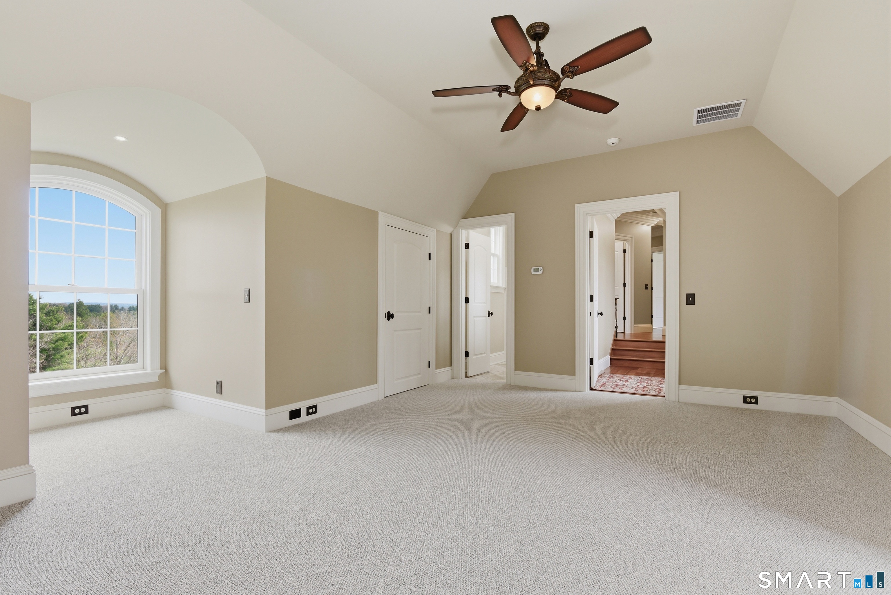 282 Searles Road Pomfret, CT 06259 - Photo 38 of 40 The luxurious in-law suite includes 2 spacious rooms showcasing architectural detail, vaulted ceilings 9+ feet, arched windows, and direct access to the adjoining full bath. Private entries through garage and also back staircase in the home.