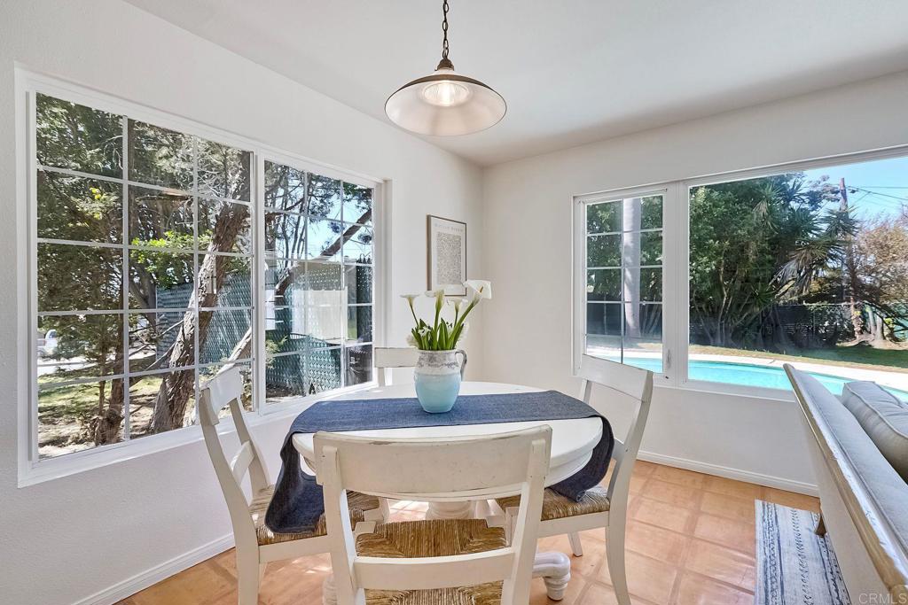 3897 Park Drive Carlsbad, CA 92008 - Photo 15 of 39 a view of a dining room with furniture wooden floor and a chandelier