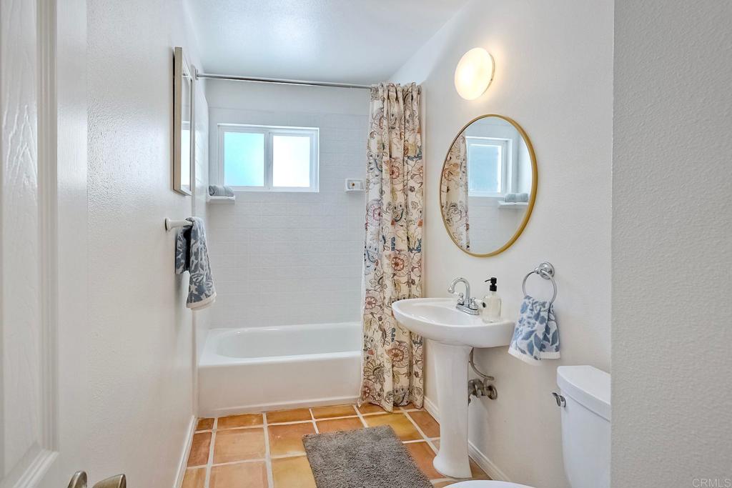 3897 Park Drive Carlsbad, CA 92008 - Photo 19 of 39 a bathroom with a sink a toilet and a mirror