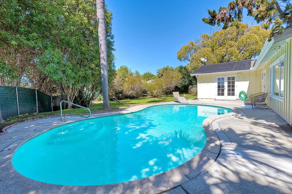 3897 Park Drive Carlsbad, CA 92008 - Photo 5 of 39 a view of a backyard with table and chairs potted plants and large tree