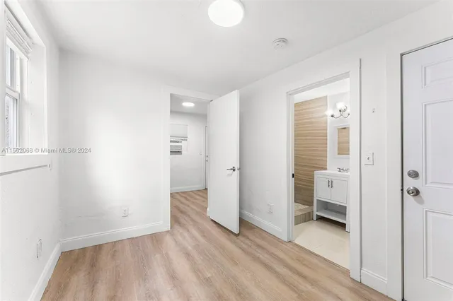 a view of a room with wooden floor and windows
