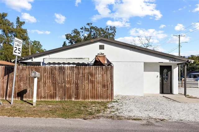 a view of a house with a wooden fence