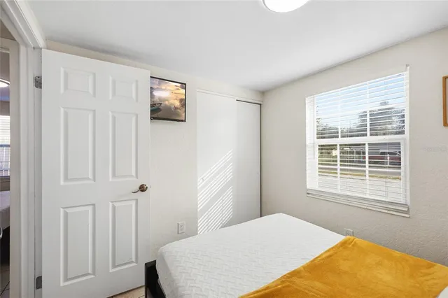 a bedroom with a bed and a window