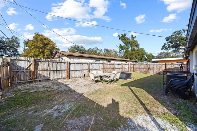 a view of a backyard with sitting area