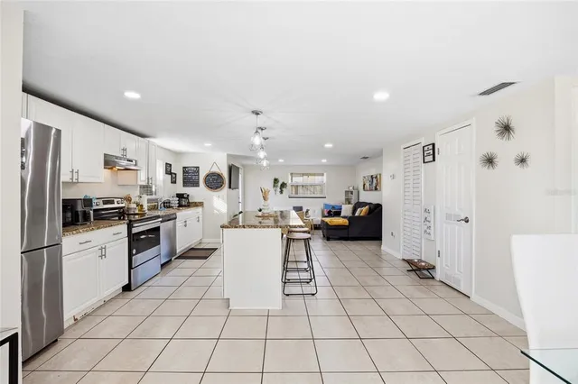 a kitchen with a sink and white cabinets