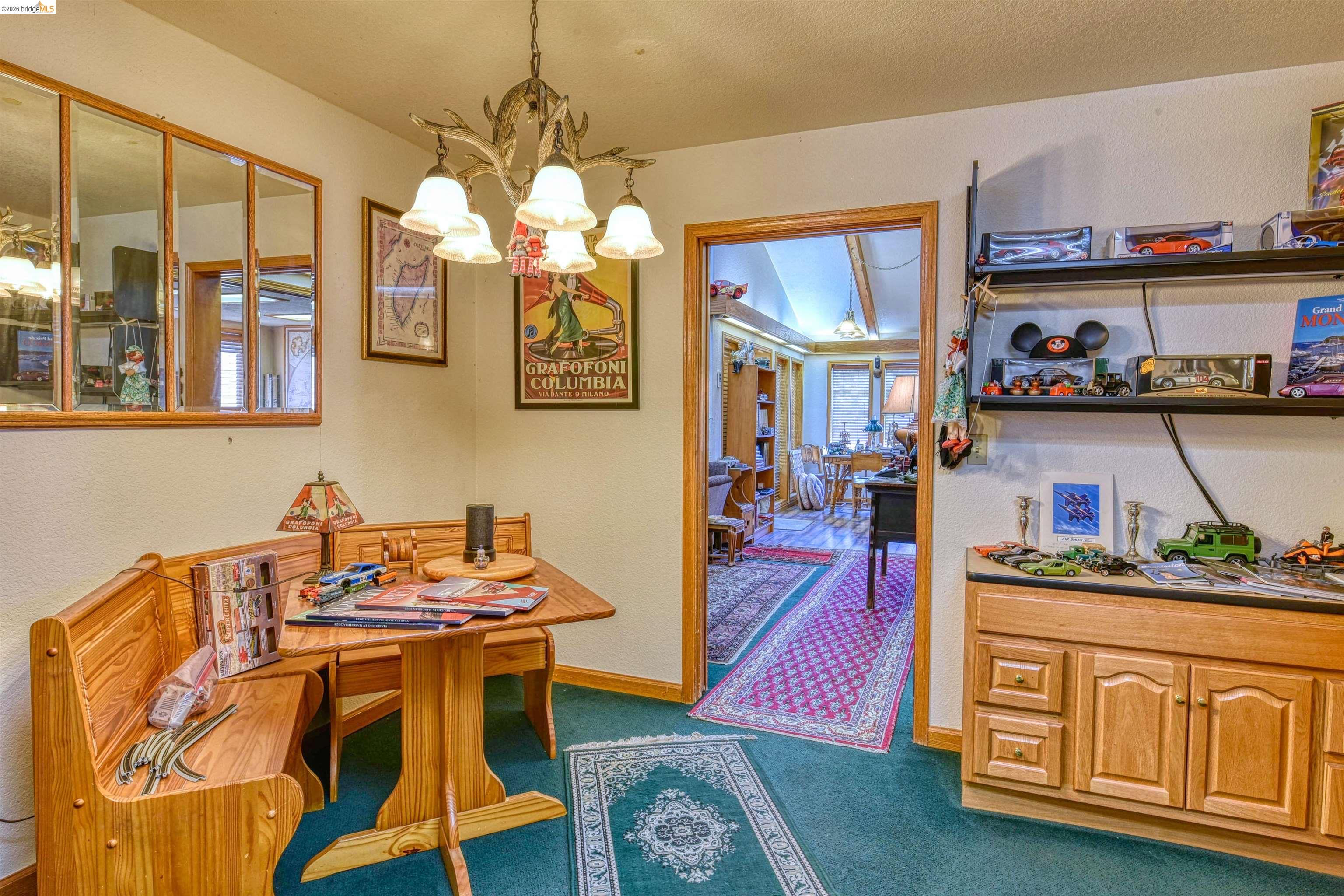 20950 Ferretti Road Groveland, CA 95321 - Photo 18 of 27 a view of a dining room with furniture and chandelier