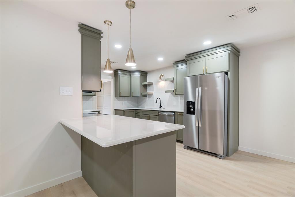 1195 33rd Street Southeast Paris, TX 75460 - Photo 10 of 34 a kitchen with stainless steel appliances a refrigerator and a sink