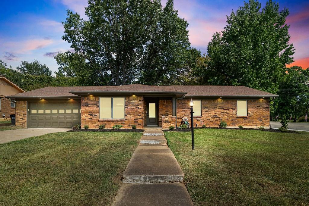 1195 33rd Street Southeast Paris, TX 75460 - Photo 24 of 34 a front view of a house with a yard and trees