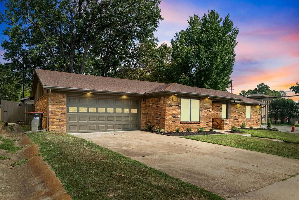 1195 33rd Street Southeast Paris, TX 75460 - Photo 25 of 34 a front view of a house with a yard and garage
