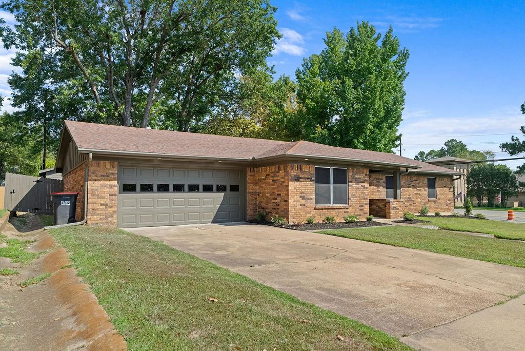 1195 33rd Street Southeast Paris, TX 75460 - Photo 26 of 34 a view of a house with a yard and garage